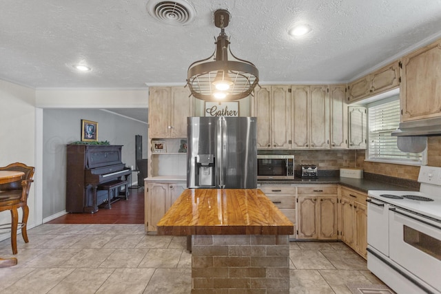 kitchen featuring stainless steel appliances, light tile patterned flooring, decorative backsplash, and a center island