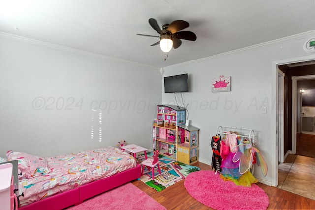 bedroom with hardwood / wood-style flooring, ceiling fan, and crown molding