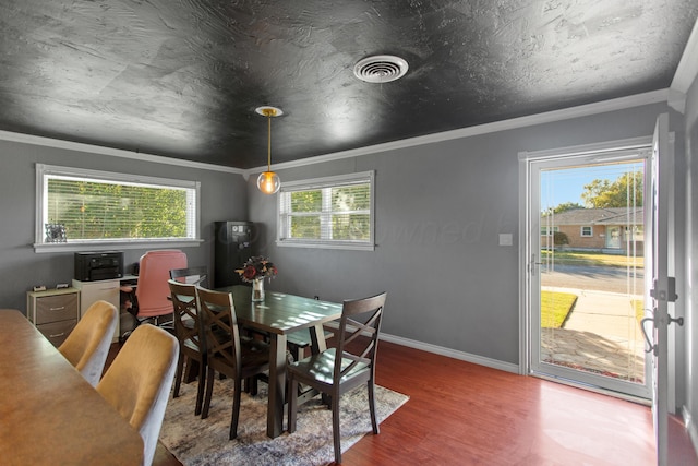 dining room with wood-type flooring and ornamental molding