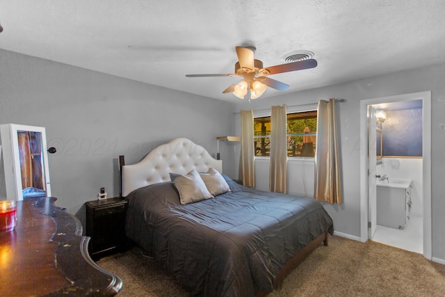 carpeted bedroom featuring a textured ceiling, ceiling fan, and connected bathroom