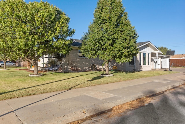 obstructed view of property with a front lawn