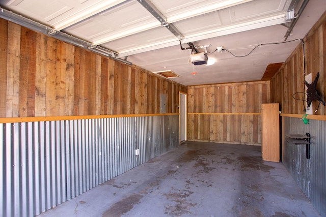 4417 Andrews Ave, Amarillo, TX 79106 - garage featuring a garage door opener and wooden walls