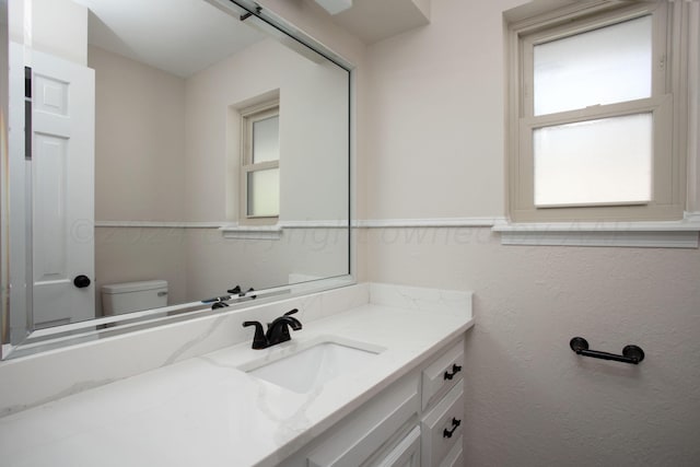 bathroom featuring vanity and toilet