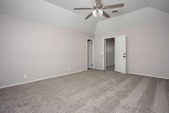 empty room featuring ceiling fan, carpet flooring, and vaulted ceiling