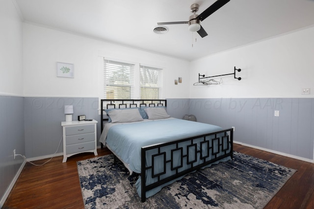 bedroom with ceiling fan, ornamental molding, and dark hardwood / wood-style floors