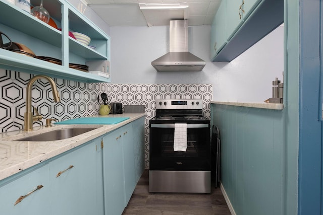 kitchen with wall chimney exhaust hood, sink, stainless steel range with electric stovetop, dark hardwood / wood-style flooring, and light stone countertops