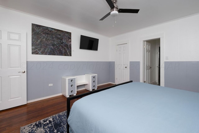 bedroom with dark hardwood / wood-style flooring, ornamental molding, and ceiling fan