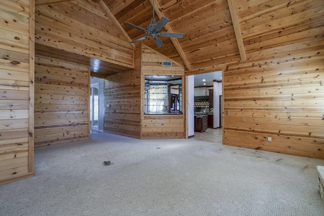 212 S Timbercreek Dr, Amarillo, TX 79118 - unfurnished living room featuring wood walls, ceiling fan, light colored carpet, wooden ceiling, and beamed ceiling