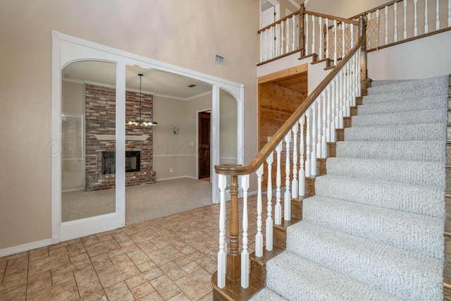 212 S Timbercreek Dr, Amarillo, TX 79118 - stairway with a high ceiling, arched walkways, baseboards, a fireplace, and ornamental molding