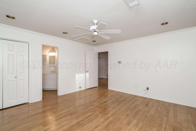 212 S Timbercreek Dr, Amarillo, TX 79118 - unfurnished bedroom featuring light wood-style floors, ornamental molding, a textured ceiling, baseboards, and ensuite bath