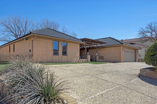 view of front of home with brick siding, concrete driveway, a garage, and a pergola