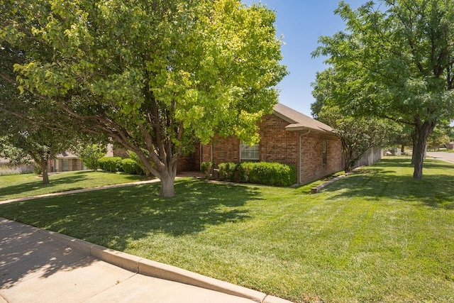 6611 Admiral Ct, Amarillo, TX 79124 - view of home's exterior with a lawn and brick siding