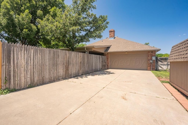 6611 Admiral Ct, Amarillo, TX 79124 - view of property exterior featuring brick siding, a chimney, a garage, driveway, and roof with shingles