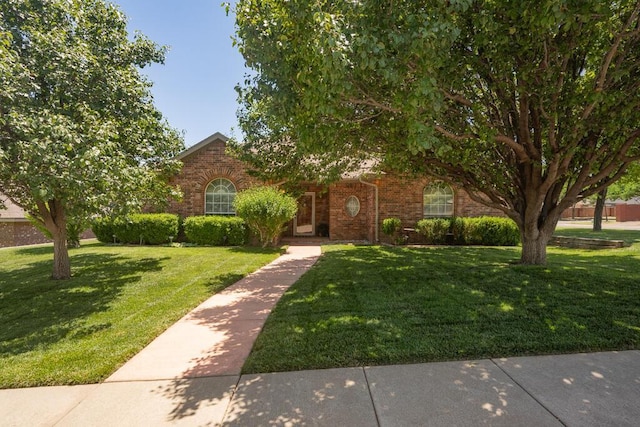 6611 Admiral Ct, Amarillo, TX 79124 - obstructed view of property featuring a front lawn and brick siding