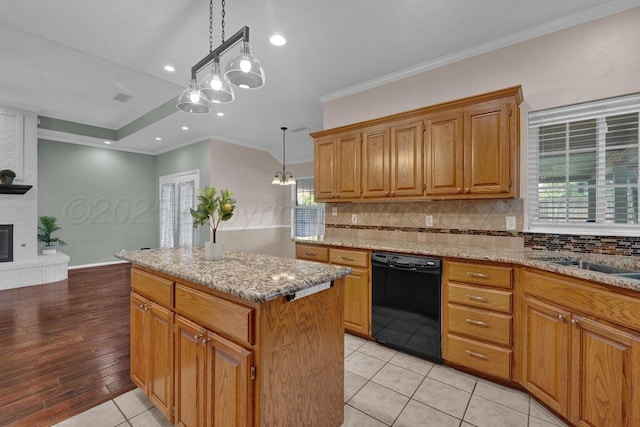 6611 Admiral Ct, Amarillo, TX 79124 - kitchen with black dishwasher, a center island, backsplash, light stone counters, and crown molding