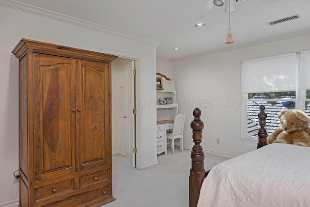 2606 S Lipscomb St, Amarillo, TX 79109 - bedroom with light carpet, built in desk, ceiling fan, and ornamental molding