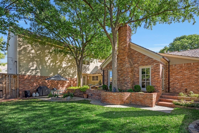 2606 S Lipscomb St, Amarillo, TX 79109 - back of house featuring brick siding, a chimney, and a yard