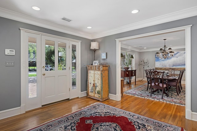 2606 S Lipscomb St, Amarillo, TX 79109 - entrance foyer featuring hardwood / wood-style flooring, crown molding, and a notable chandelier