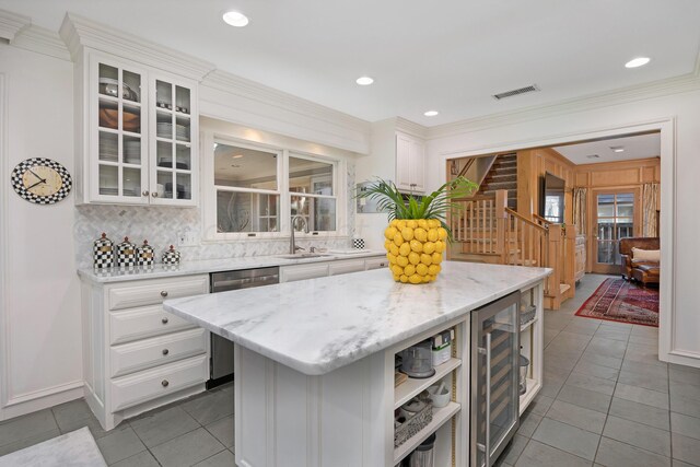 2606 S Lipscomb St, Amarillo, TX 79109 - kitchen with wine cooler, a sink, decorative backsplash, stainless steel dishwasher, and white cabinets