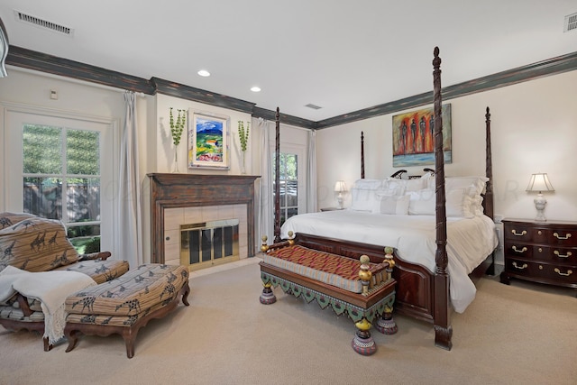 2606 S Lipscomb St, Amarillo, TX 79109 - bedroom with light carpet, ornamental molding, and a tiled fireplace