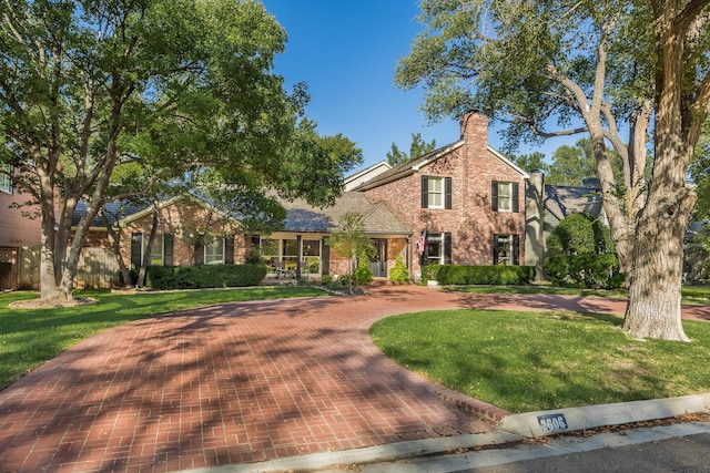 2606 S Lipscomb St, Amarillo, TX 79109 - traditional-style home with brick siding, a front lawn, and a chimney