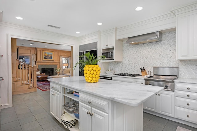 2606 S Lipscomb St, Amarillo, TX 79109 - kitchen featuring gas cooktop, light tile patterned floors, stainless steel microwave, white cabinetry, and decorative backsplash