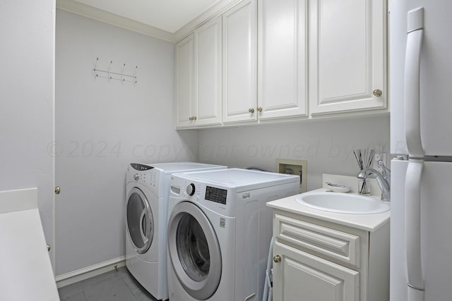 2606 S Lipscomb St, Amarillo, TX 79109 - laundry area featuring cabinets, washing machine and dryer, ornamental molding, and sink