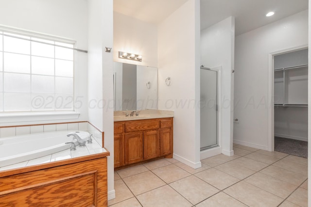 6203 Donda St, Amarillo, TX 79118 - full bath with a shower stall, vanity, a bath, a spacious closet, and tile patterned flooring