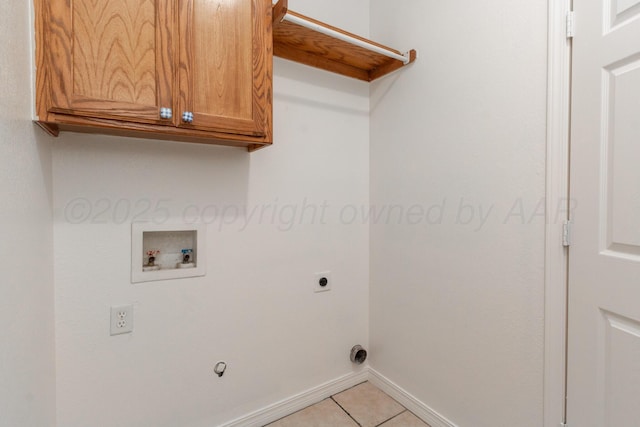 6203 Donda St, Amarillo, TX 79118 - laundry area featuring washer hookup, electric dryer hookup, light tile patterned floors, and cabinet space