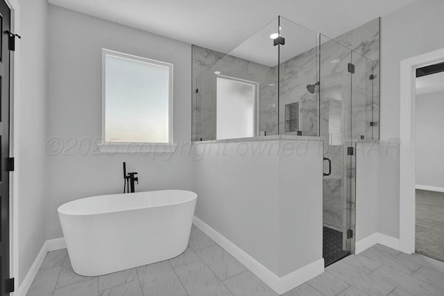 full bath featuring marble finish floor, baseboards, a freestanding bath, and a marble finish shower