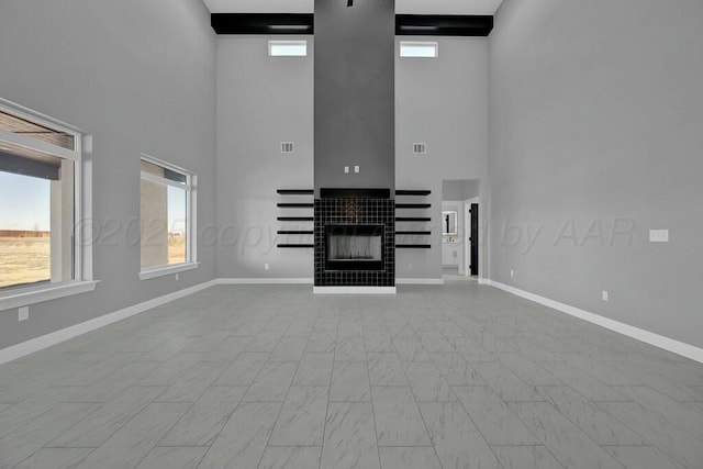 unfurnished living room with a fireplace, visible vents, and baseboards