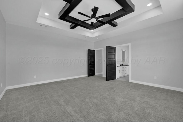 unfurnished bedroom featuring recessed lighting, carpet, a raised ceiling, and baseboards