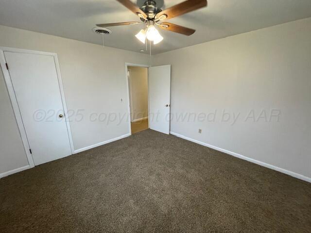 1805 N Jefferson St, Amarillo, TX 79107 - unfurnished bedroom featuring dark colored carpet and ceiling fan
