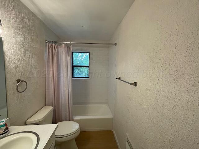 1805 N Jefferson St, Amarillo, TX 79107 - bathroom featuring vanity, a textured wall, shower / bath combo, and wood finished floors
