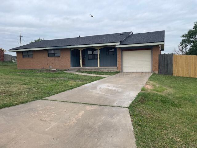 1805 N Jefferson St, Amarillo, TX 79107 - ranch-style home featuring driveway, brick siding, an attached garage, and a porch