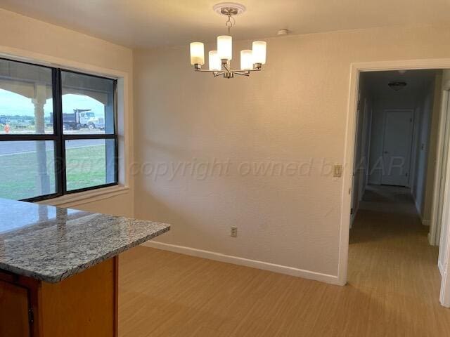 1805 N Jefferson St, Amarillo, TX 79107 - unfurnished dining area with light wood-type flooring and a chandelier