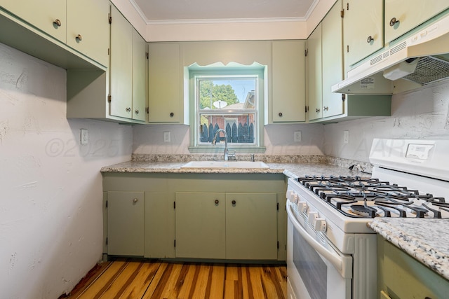 4002 S Tyler St, Amarillo, TX 79110 - kitchen featuring white gas range, under cabinet range hood, light wood-style floors, light countertops, and ornamental molding