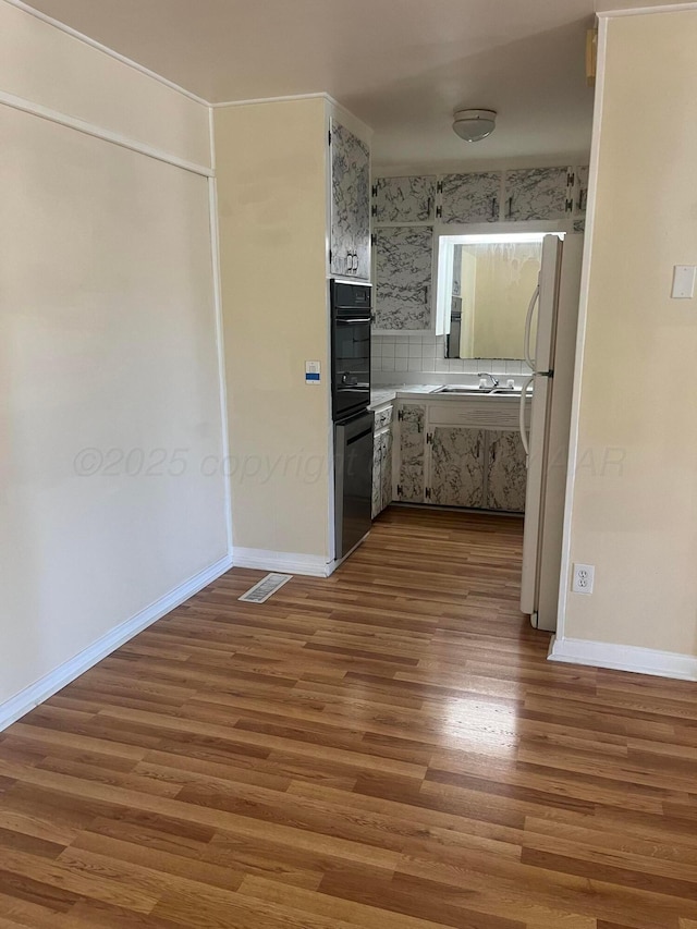 1565 Bell St, Amarillo, TX 79106 - interior space featuring wood finished floors, baseboards, and a sink