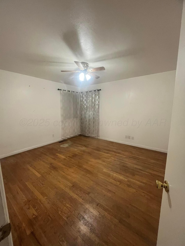 1565 Bell St, Amarillo, TX 79106 - empty room featuring wood finished floors, a ceiling fan, and baseboards
