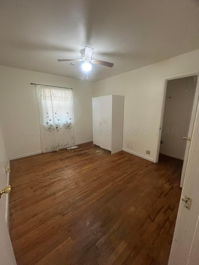 1565 Bell St, Amarillo, TX 79106 - unfurnished bedroom featuring wood finished floors, baseboards, and ceiling fan