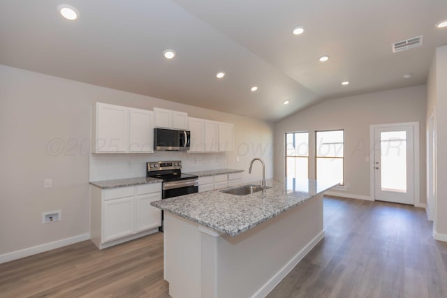 kitchen featuring visible vents, backsplash, electric range, white cabinetry, and a sink