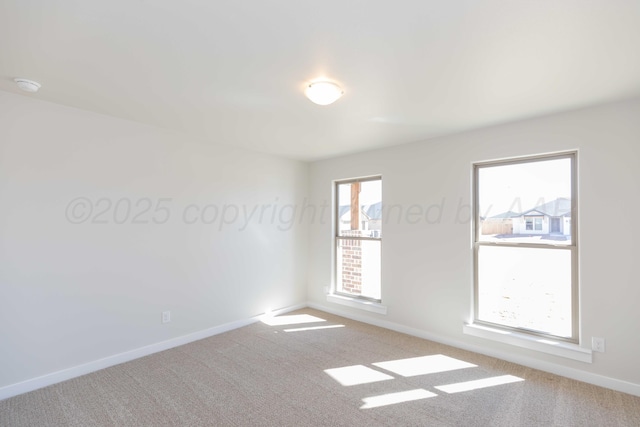 empty room with carpet flooring and baseboards