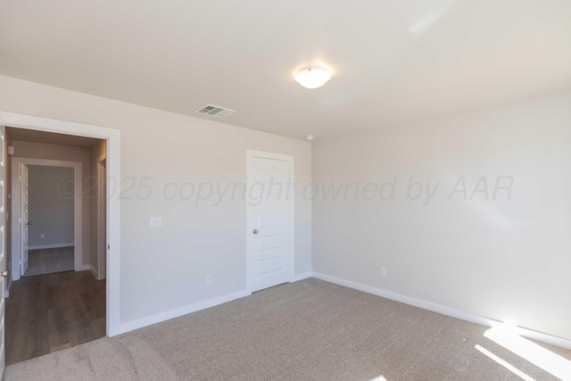 unfurnished bedroom with a closet, carpet flooring, visible vents, and baseboards