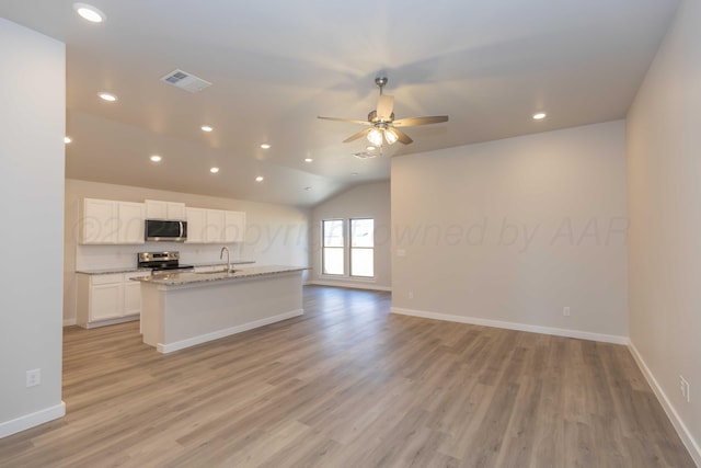 kitchen with light wood-type flooring, visible vents, stainless steel appliances, and open floor plan