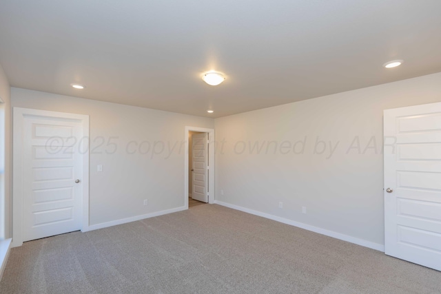 spare room with carpet floors, baseboards, and recessed lighting