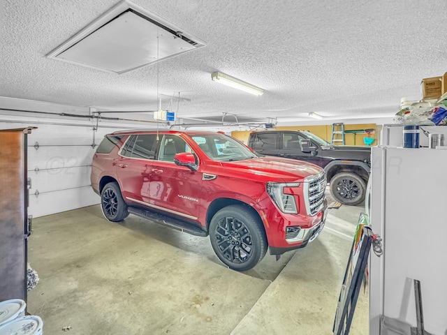 parking garage featuring freestanding refrigerator