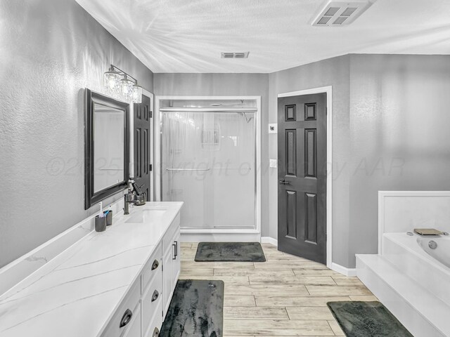 full bathroom with a garden tub, a stall shower, visible vents, and wood tiled floor