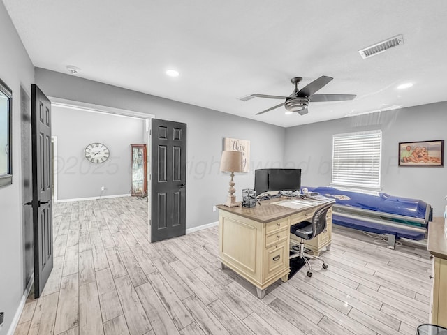 office area featuring visible vents, light wood-style flooring, baseboards, and ceiling fan