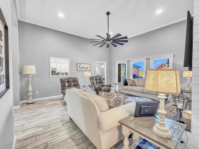 living room with baseboards, ornamental molding, recessed lighting, wood finished floors, and a ceiling fan