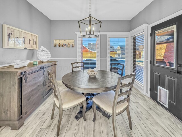 dining room with a notable chandelier and light wood-style floors